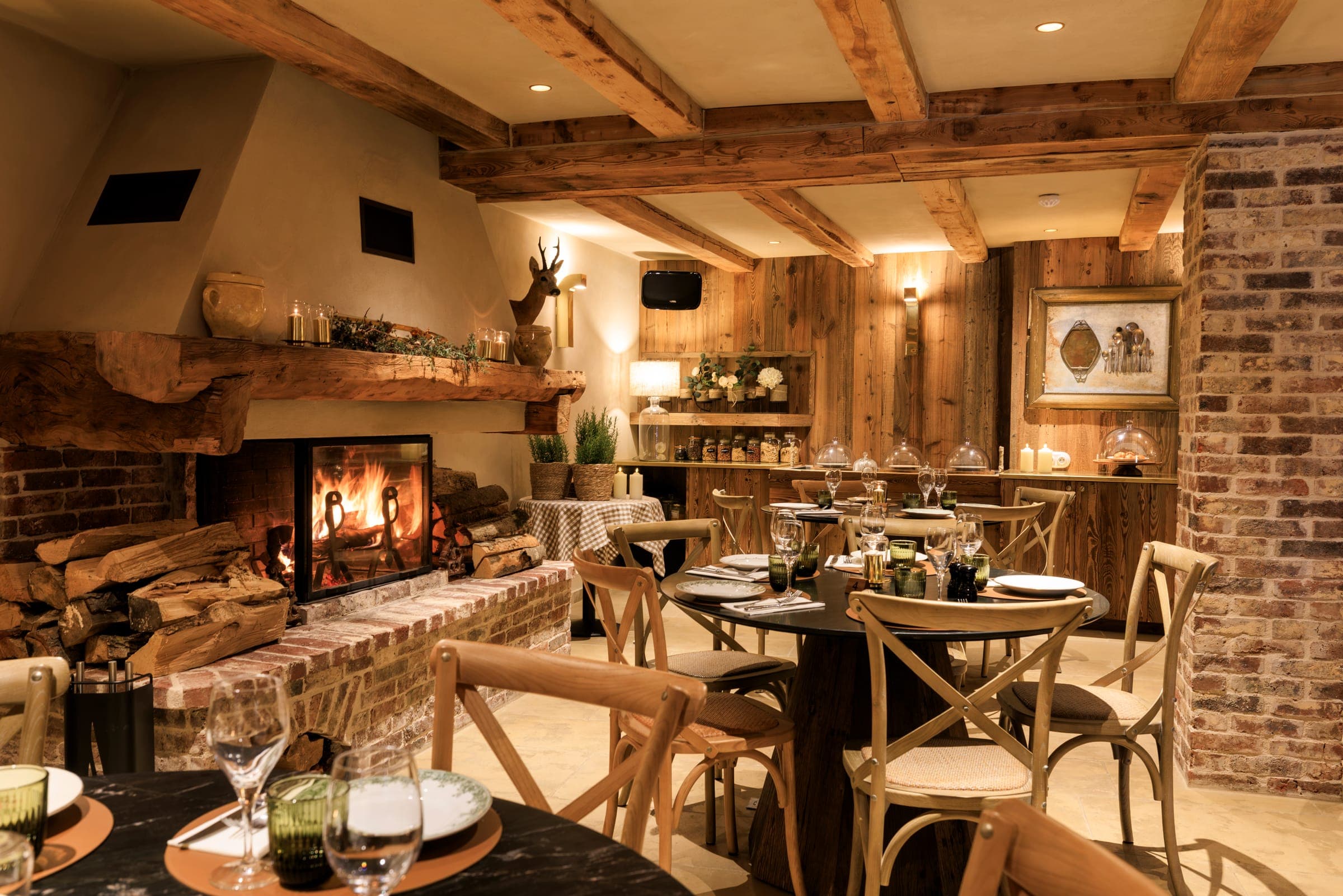 The restaurant dining room, the fire lit and the tables laid