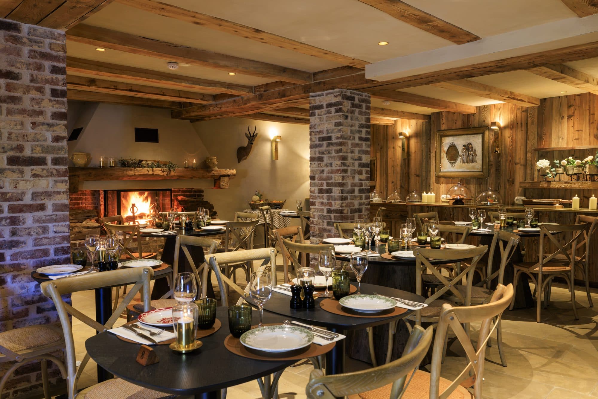 The vaulted dining room set for the evening